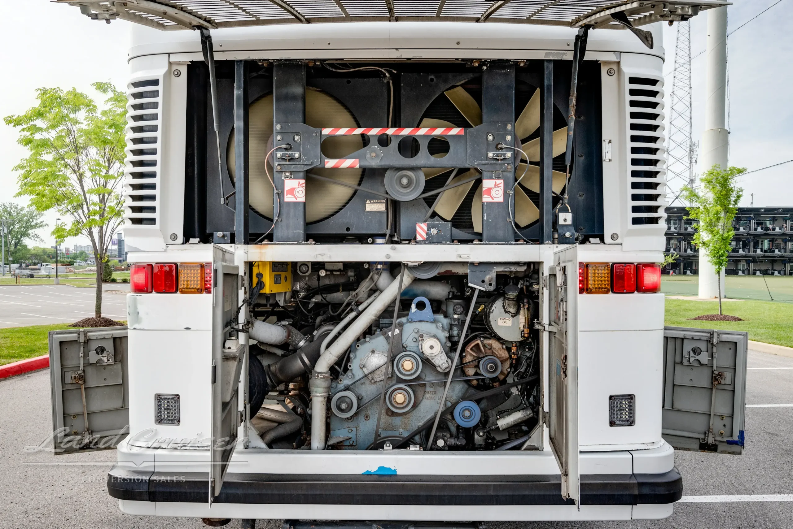 Rear engine bay of MCI coach showing mechanical components, fans, and belt system