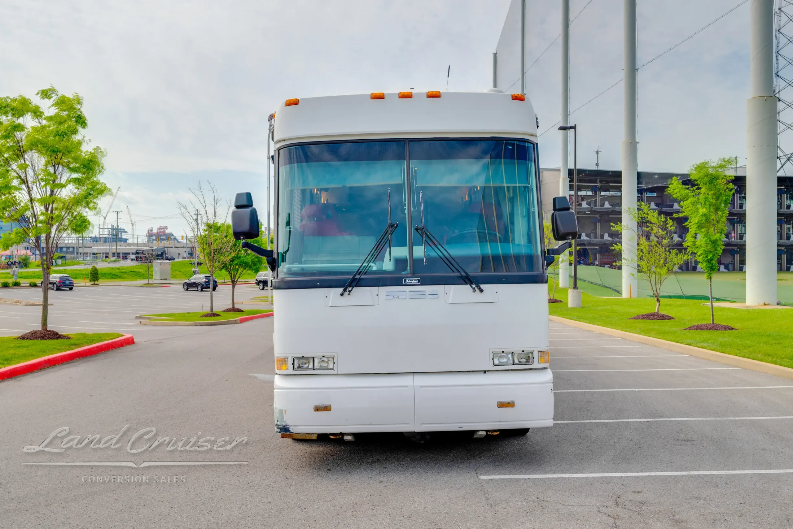 Front exterior view of 1998 MCI 102-DL3 Executive Day Coach with wide windshield and clean white body