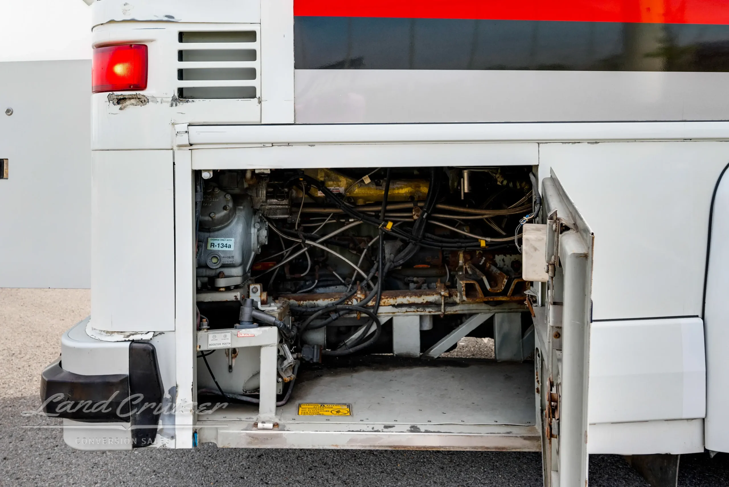 Back of MCI Executive Coach open to show Detroit Series 60 engine and belt system