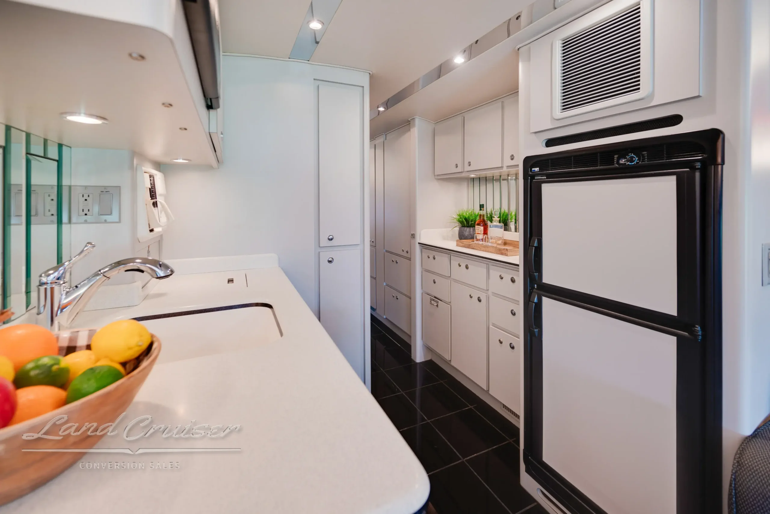 Interior layout of MCI bus showing flow from front lounge to kitchen