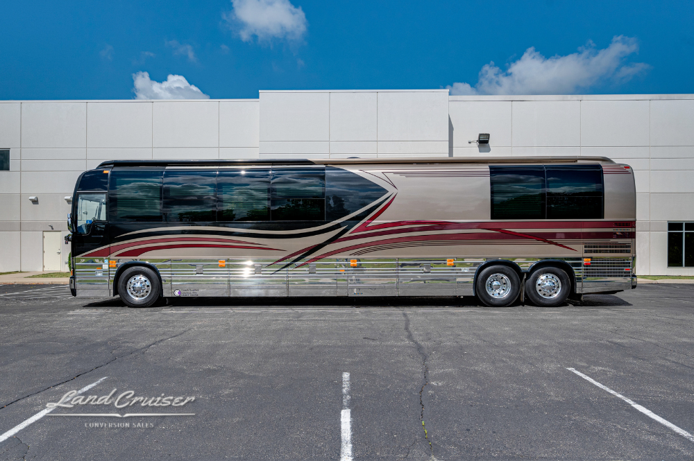 Driver-side full length image of 45-foot Prevost XLII coach parked on asphalt with clear skies