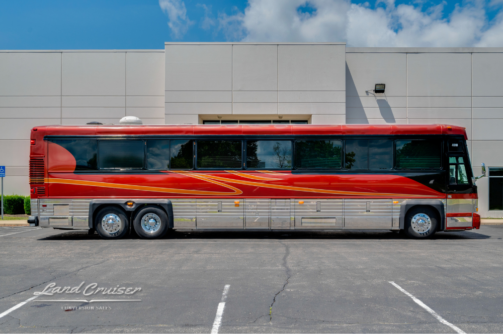 Passenger side view of Custom Coach 4510 Churchill showcasing full exterior length and tri-axle configuration