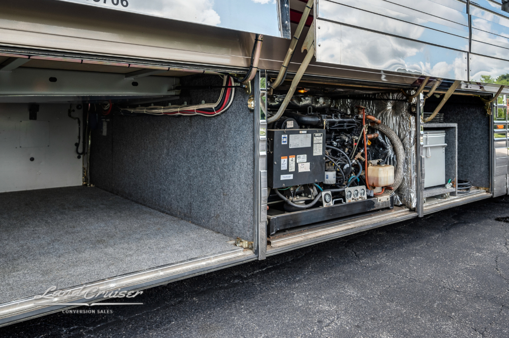 Under-bay storage showcasing generator wiring and electrical system in luxury Prevost XLII motorhome