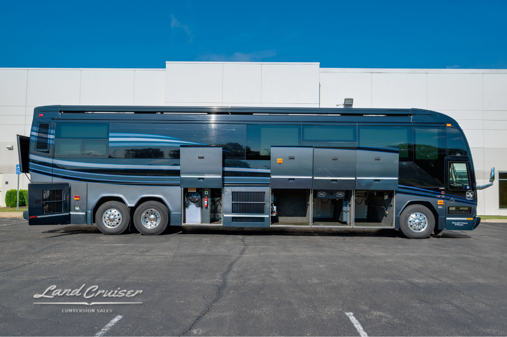 Storage bays fully open along the driver's side of the bus, revealing equipment compartments.