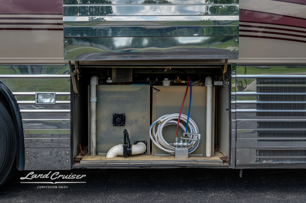 Compact water hose and plumbing bay access on luxury Prevost XLII Custom Coach