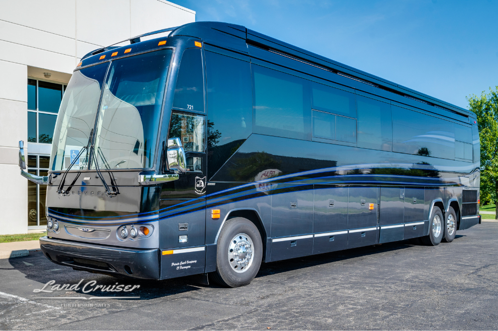 Front right view of the Aretha coach with its signature curved windshield and clean black and silver detailing.