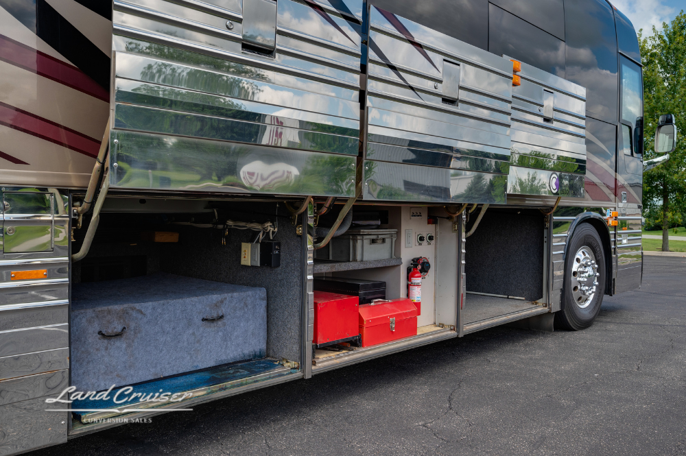 Curbside utility bays with visible generator, red tool bin, and exterior storage compartments