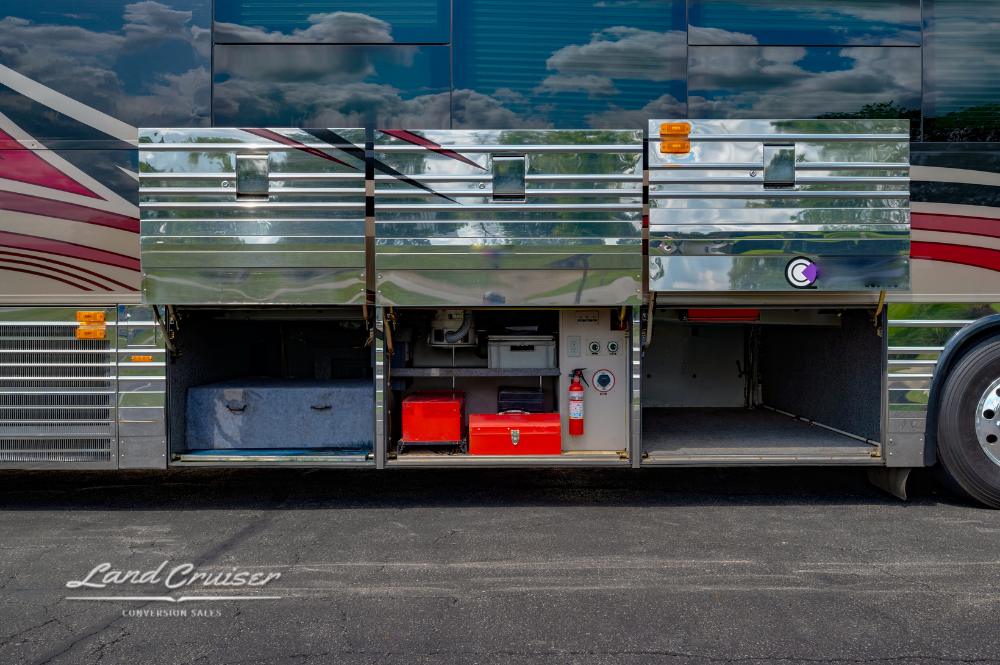 Open storage compartments featuring power systems and drawers under Prevost XLII conversion