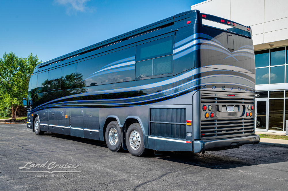 Rear angle shot of the entertainer coach, showing dual rear axles and gently sweeping body lines.