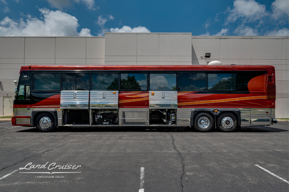 Side profile of Churchill bus with multiple lower service doors open for inspection