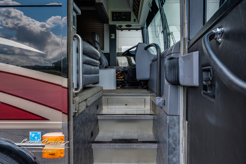 Entry steps and cockpit access door of 2002 Prevost XLII executive motorhome for sale