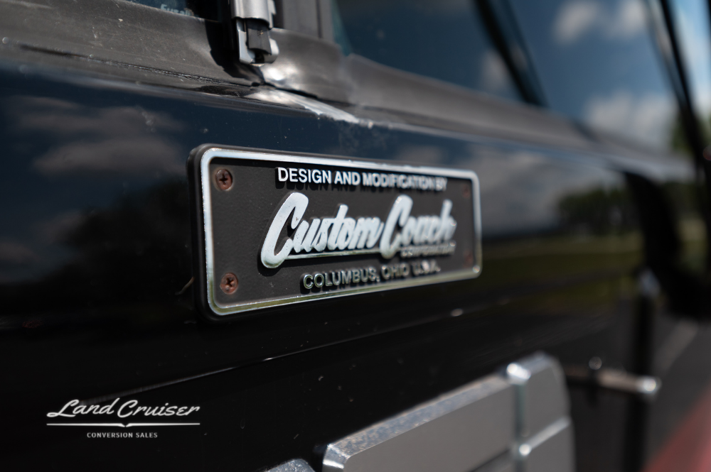 Custom Coach Corporation builder badge mounted near entry door of Churchill executive coach