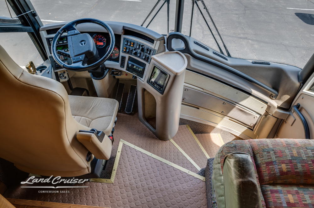 Driver’s cockpit of MCI 102EL3 with leather captain’s chair and dashboard controls