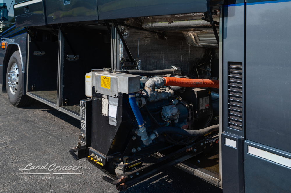 Generator bay with slide-out tray, highlighting hoses, belts, and coolant lines in full extension.