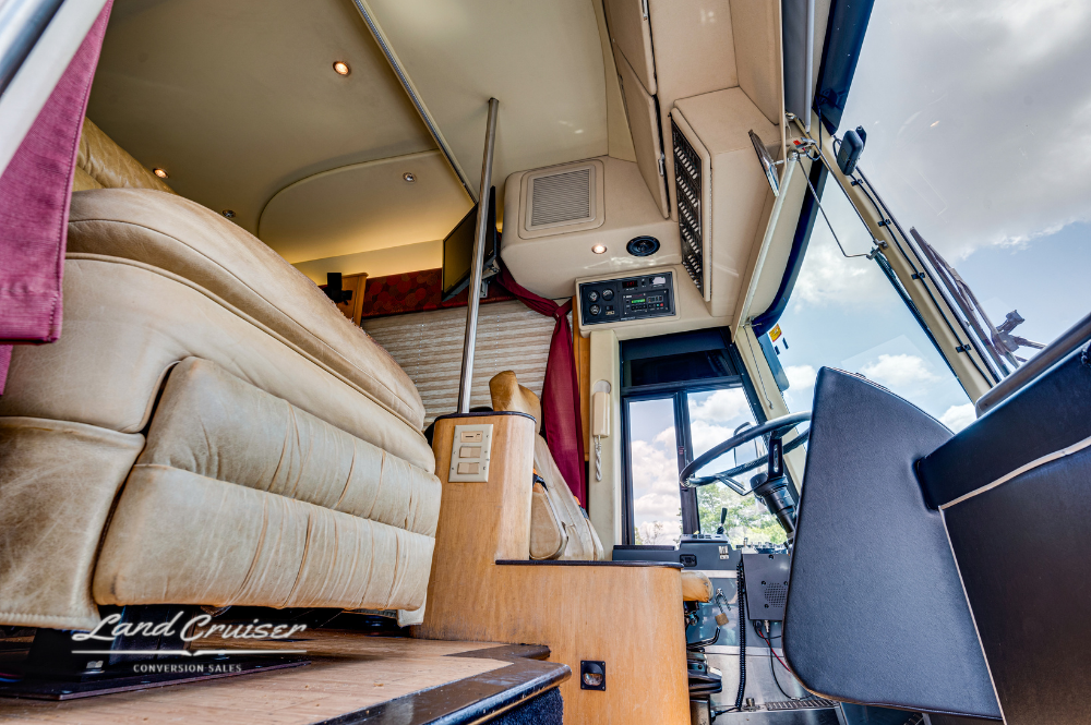 Up-close interior angle from stairwell showing front lounge and overhead storage