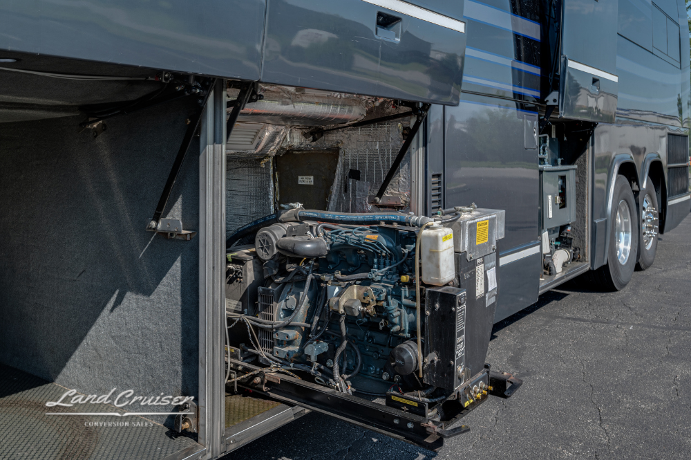 Slide-out generator tray extended from under the coach, displaying engine and wiring detail.