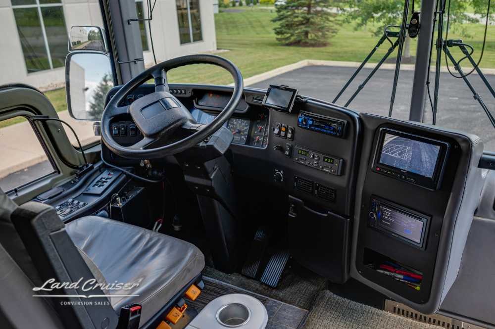 Cockpit interior of 2002 Prevost XLII showing leather captain's chair and integrated navigation display