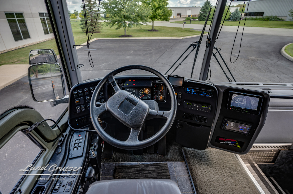 Driver's dashboard with digital gauges and touchscreen monitor in luxury Prevost XLII motorhome
