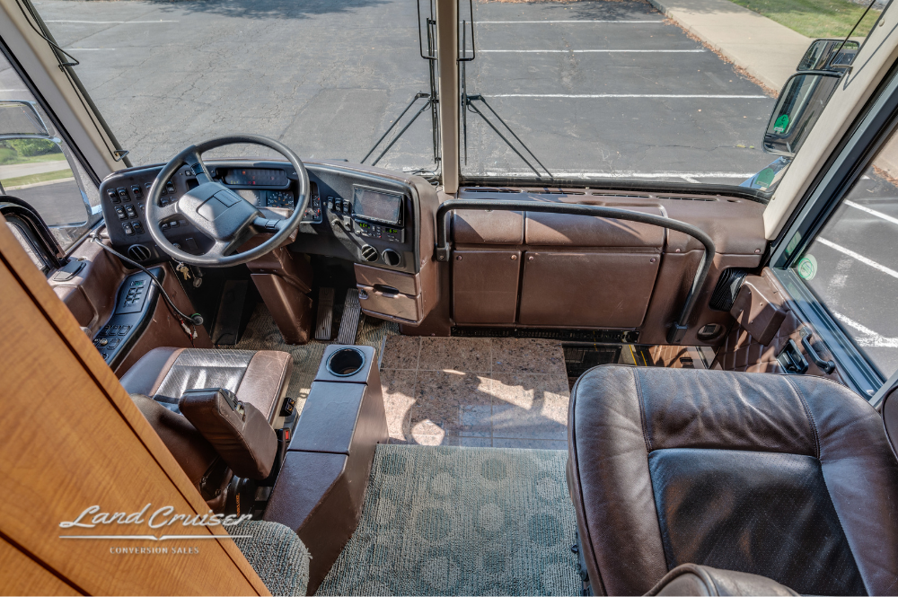Overhead view of the driver area and front passenger seating with tan and brown leather finish.