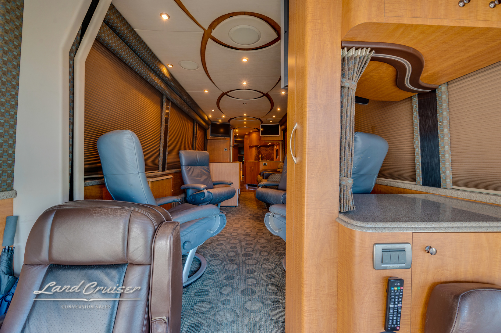 Front salon area with leather seating and rear view into the lounge and galley.