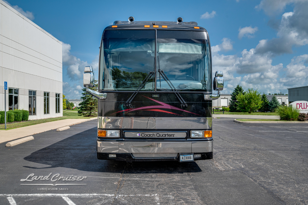 Head-on view of 2002 Prevost XLII luxury motorcoach parked in front of Columbus, OH facility