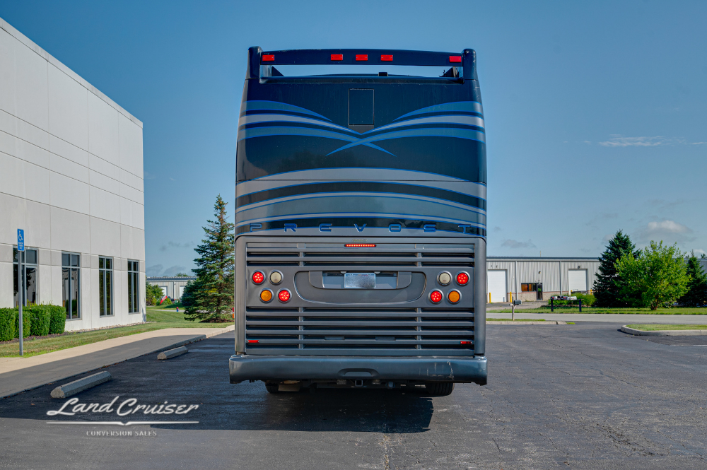Straight rear view of the Aretha bus with brake lights and rooftop HVAC system visible.