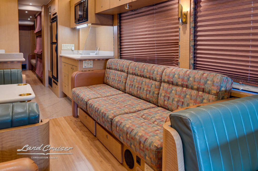 Leather sofa and dinette seating in MCI motorhome front lounge