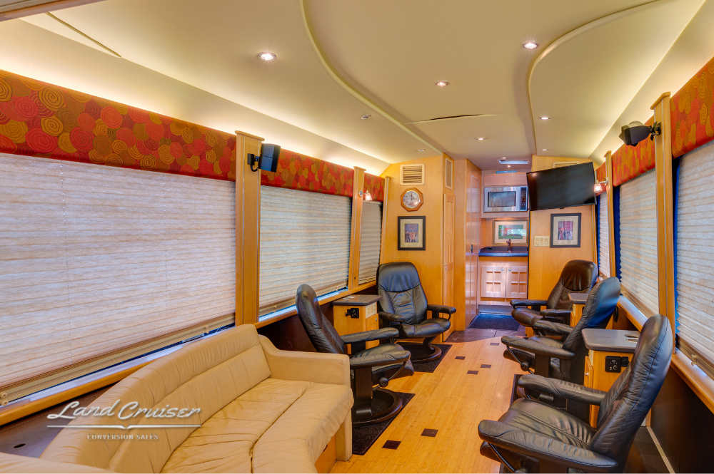 Executive rear cabin layout with leather seating, black granite flooring inlay, and media console