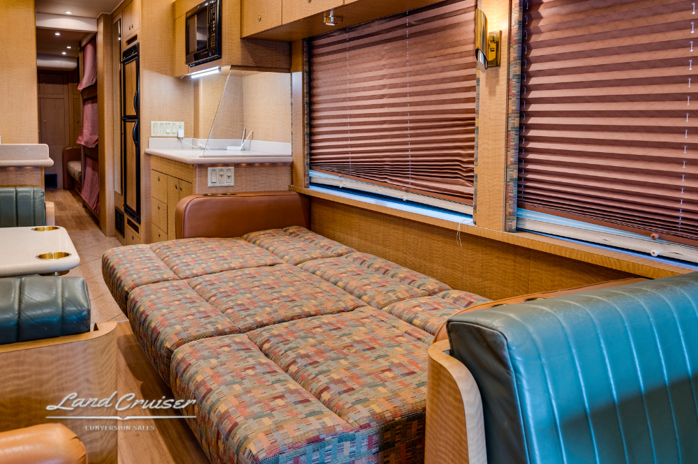 Interior view of lounge with blue and tan leather seating in MCI 102EL3