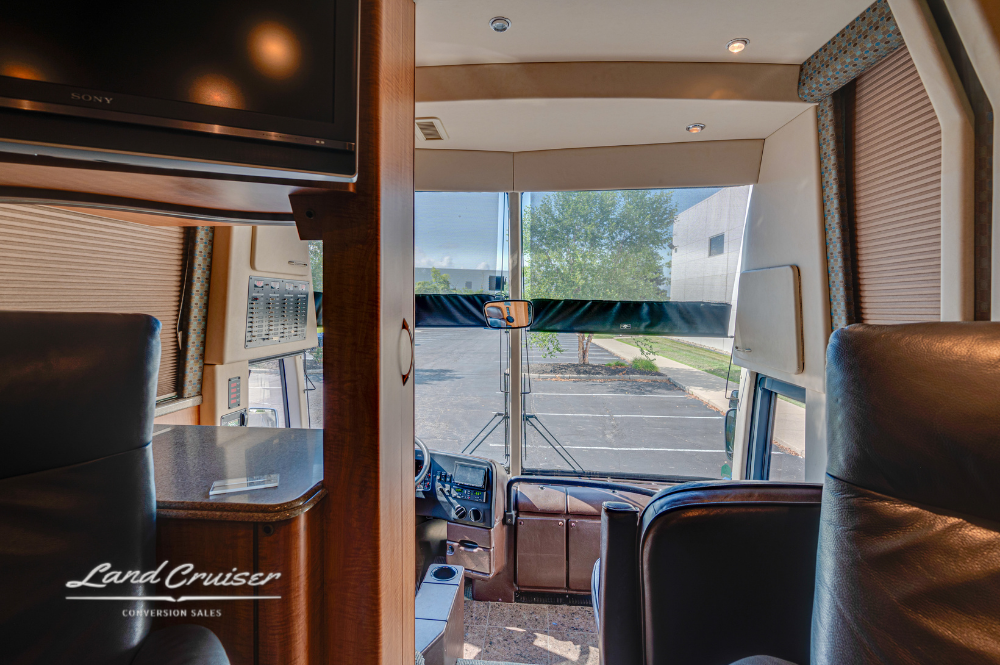 Rearward-facing shot from salon showing cockpit, TV cabinet, and living area separation.