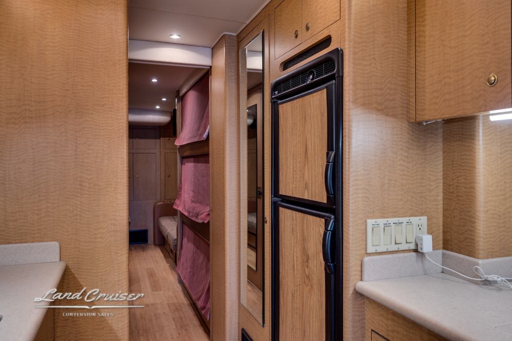 Refrigerator and pantry area in galley of MCI motorhome