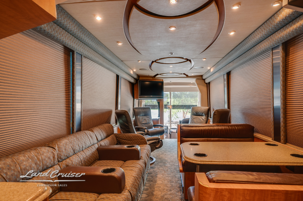 Wide view of front lounge area featuring sofas, recliners, and circular ceiling trim design.