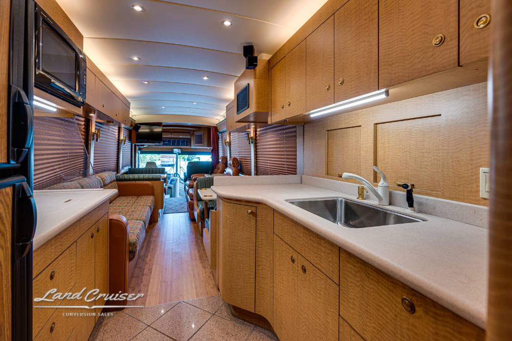 Spacious galley view showing counter space and cabinetry in MCI 102EL3 motorhome