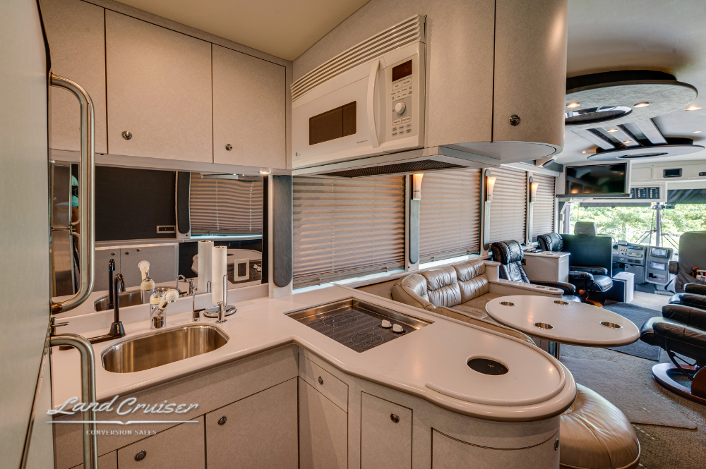 Galley interior featuring mirrored backsplash, undercounter lighting, and full cooking amenities