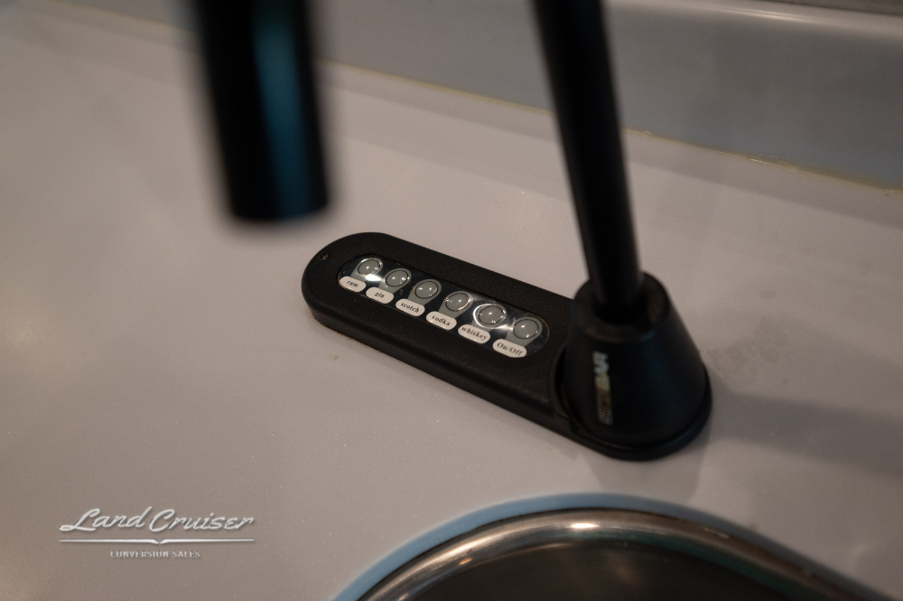 Close-up of residential faucet and sink controls in VIP bus galley or bath area