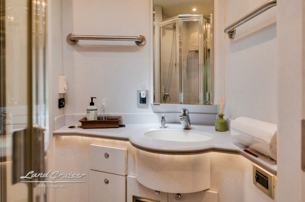 Spacious Prevost XLII bathroom with wraparound vanity, mirror, and full-size sink