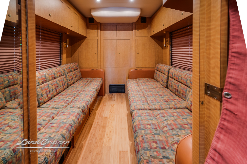 Bunk area with patterned bedding and overhead lighting in MCI 102EL3