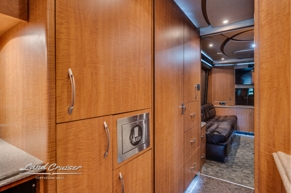 Custom cabinetry with integrated washer-dryer and closed storage drawers in hallway.