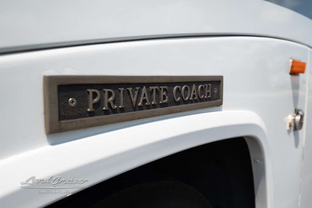 Close-up of “Private Coach” emblem on side of MCI 102EL3 motorhome