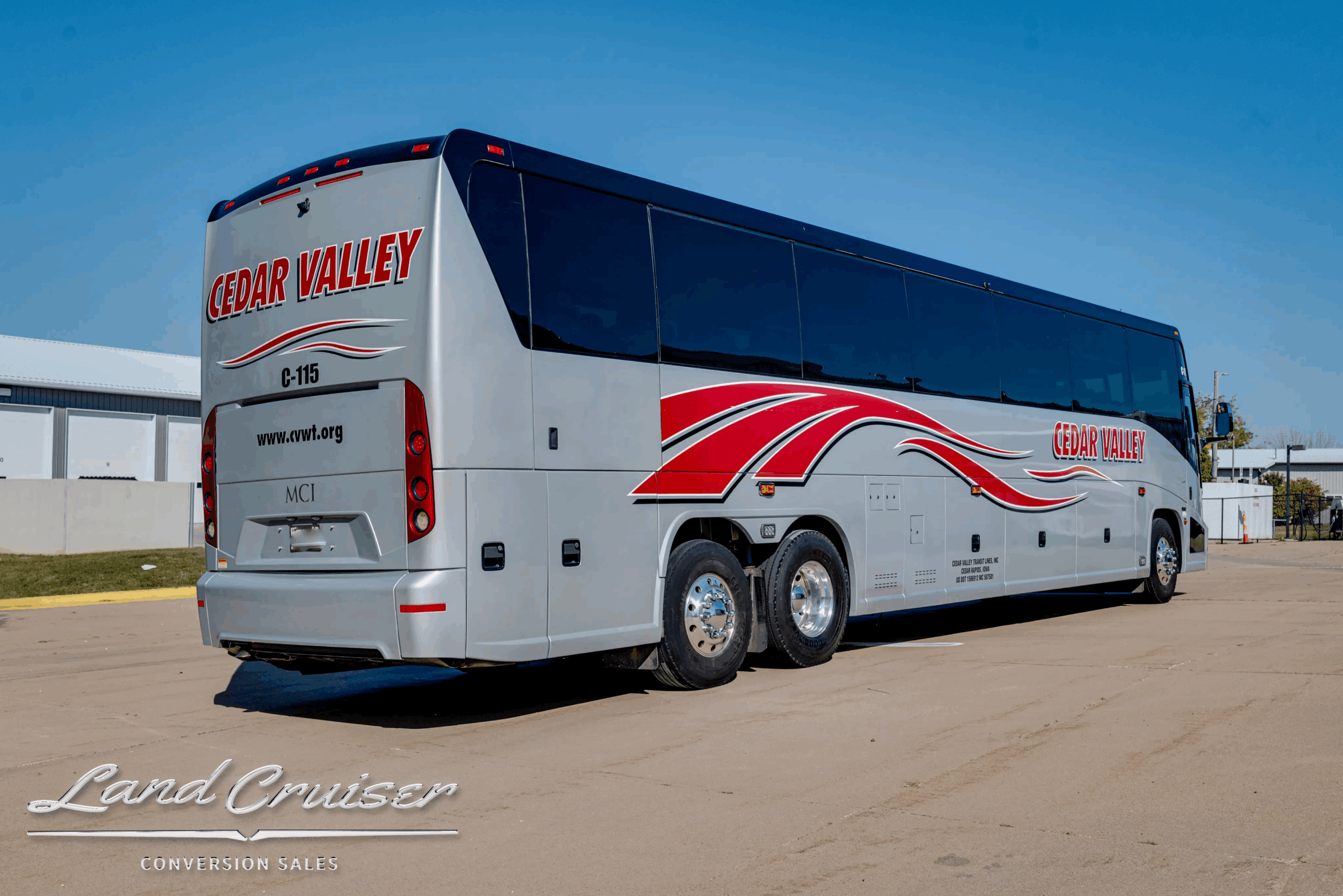 Rear-left three-quarter showing tag axle and body lines.