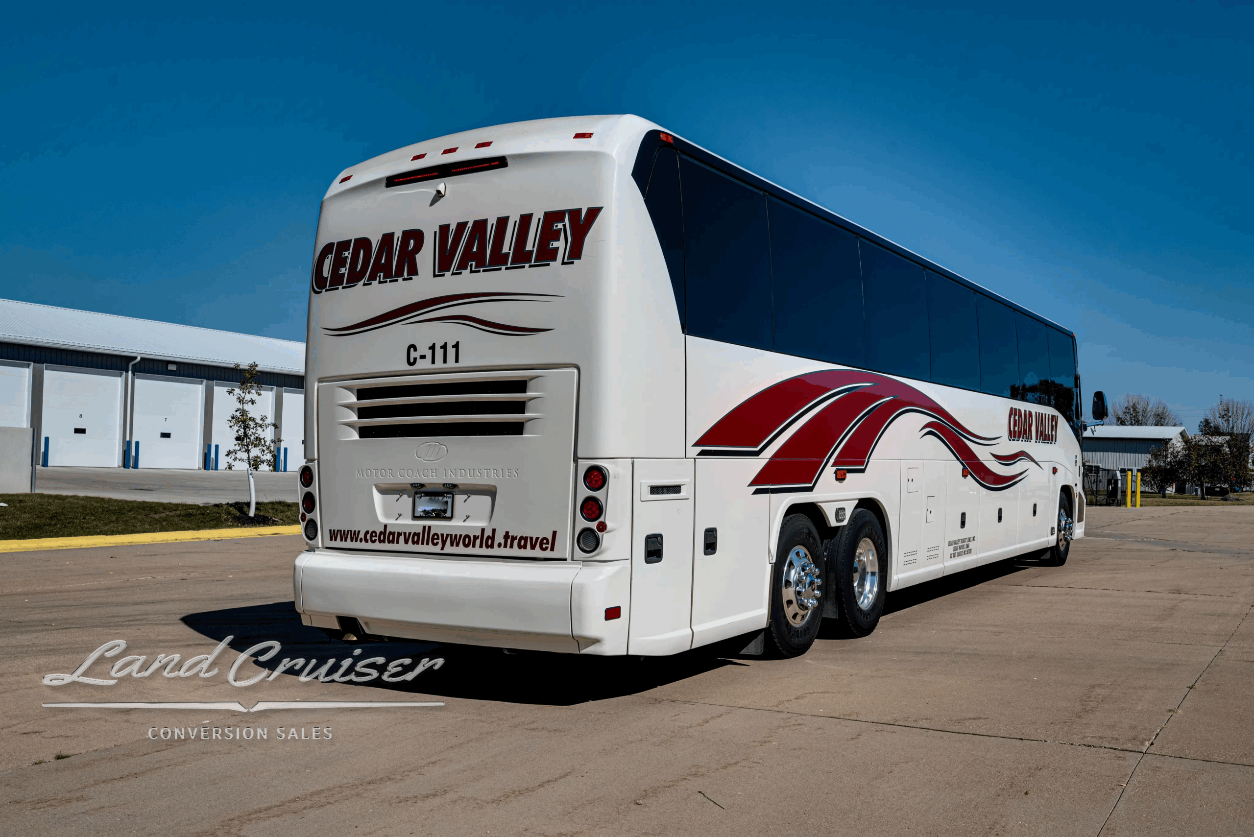 Rear-right three-quarter view of the charter coach.