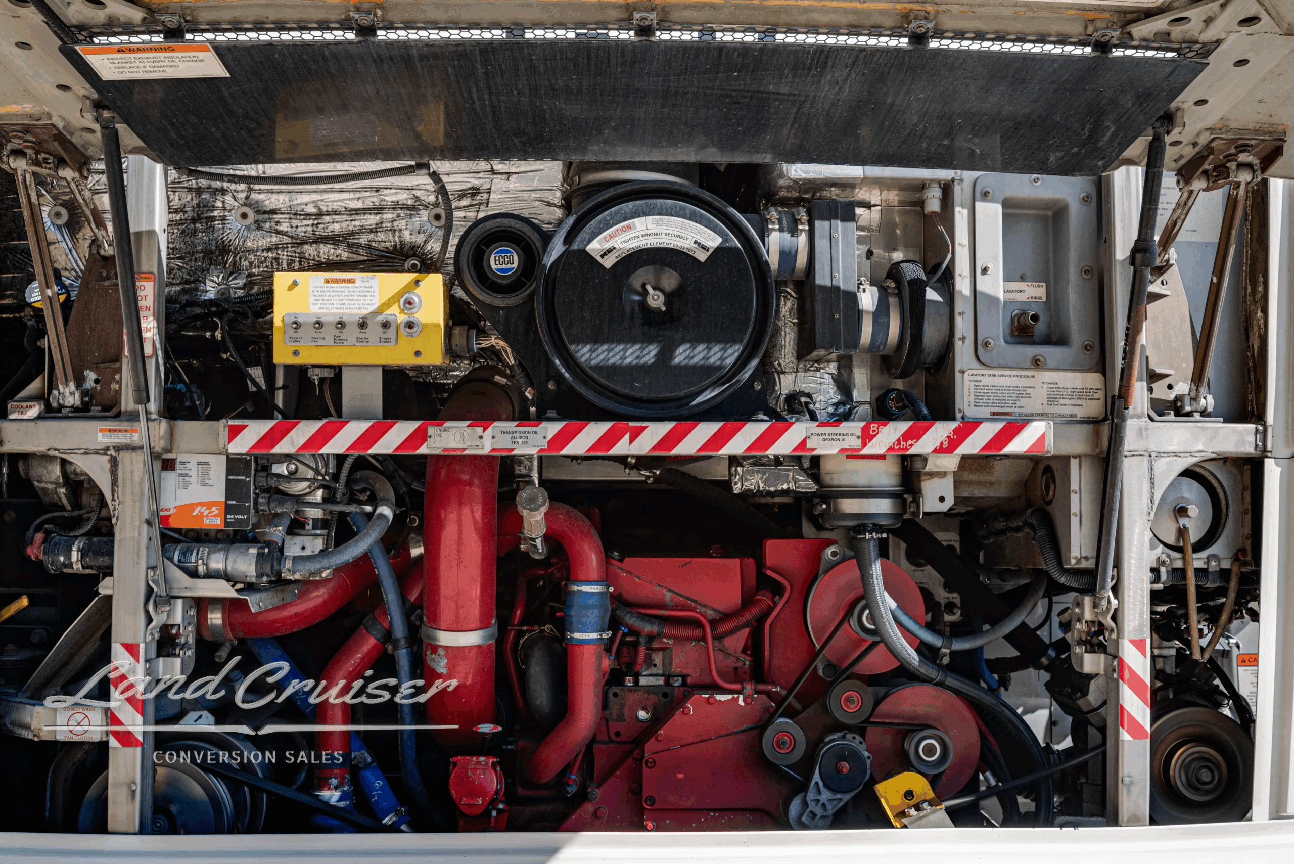 Cummins ISM 10.8L engine compartment with belts and accessories.