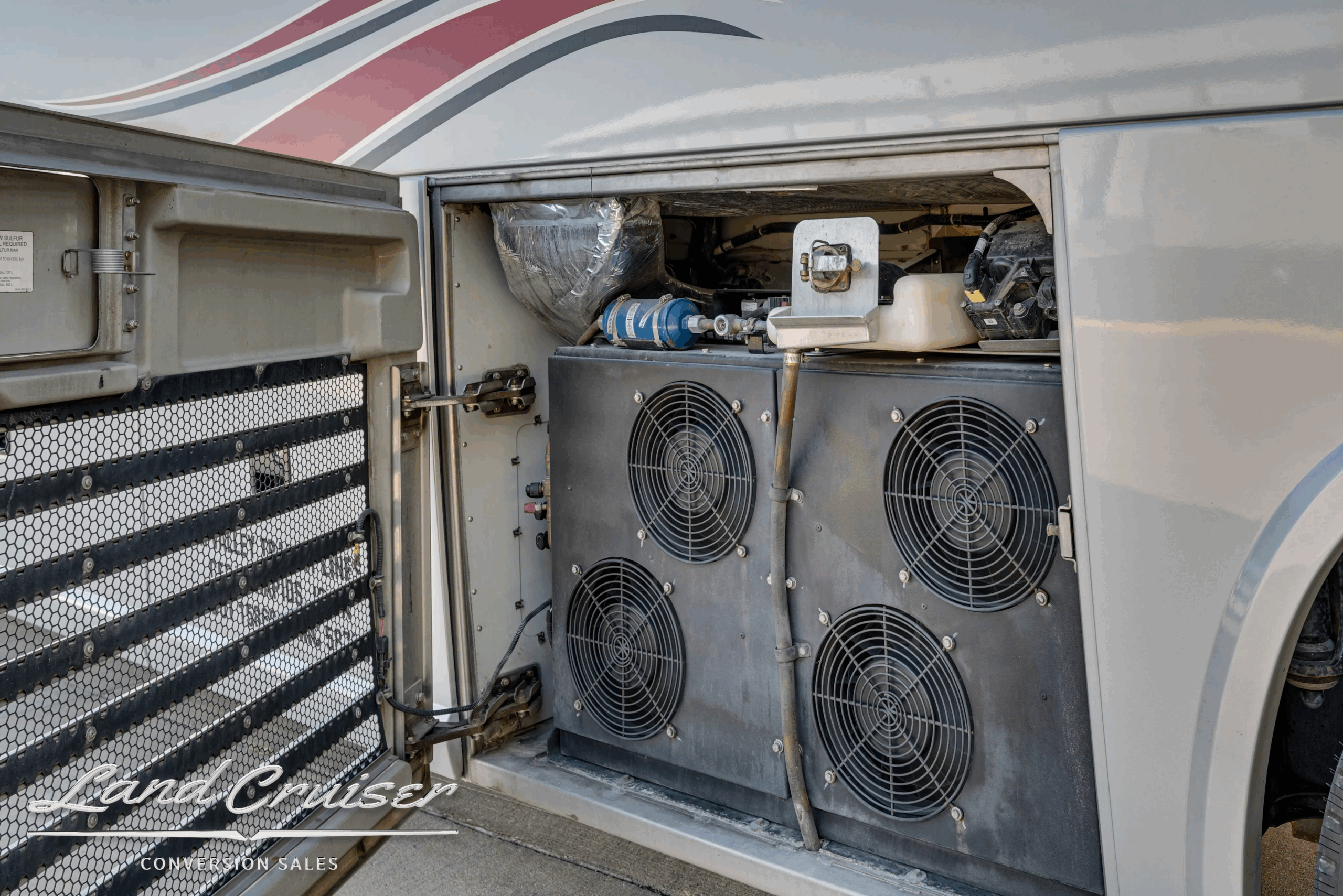 Dual condenser fans in curb-side equipment bay.