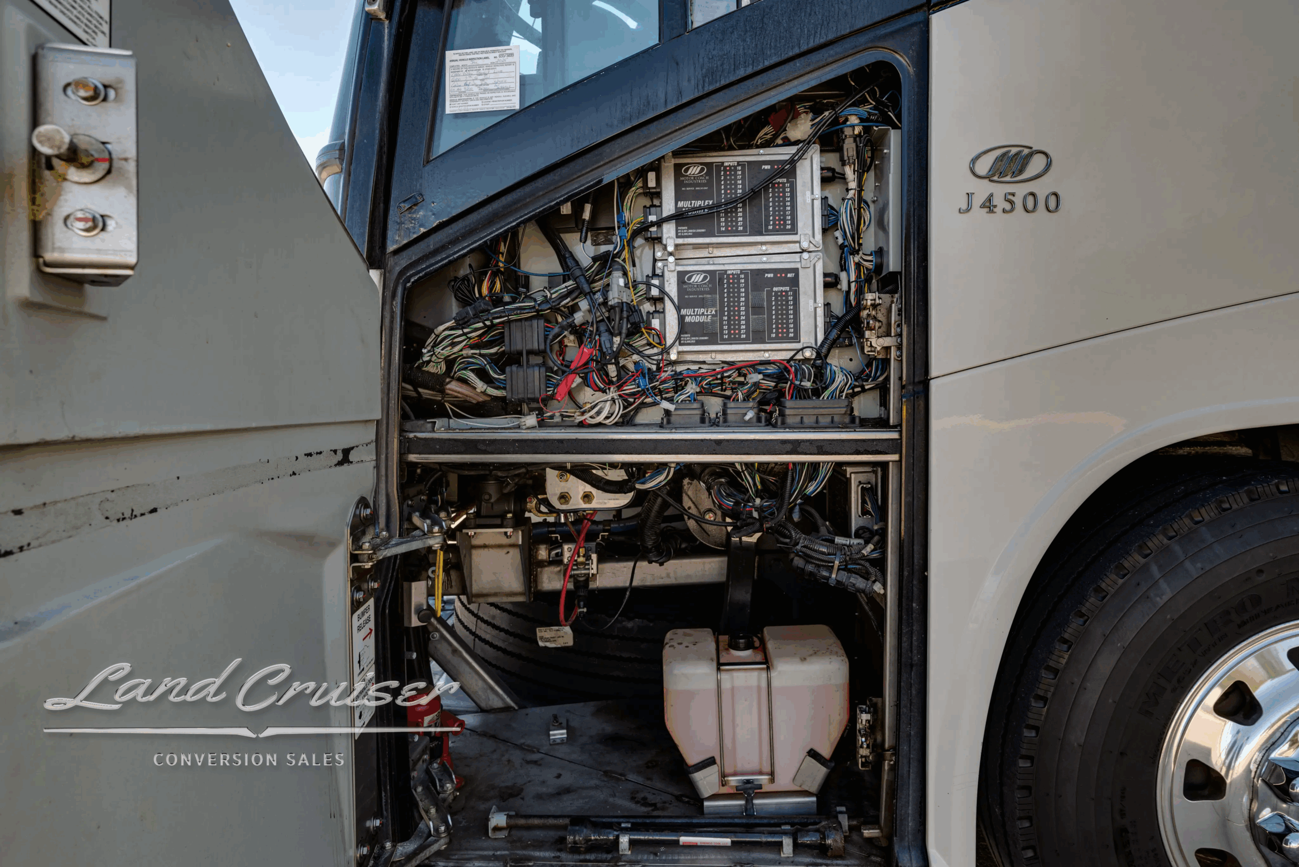 Electrical and fluid service panel inside engine compartment area.