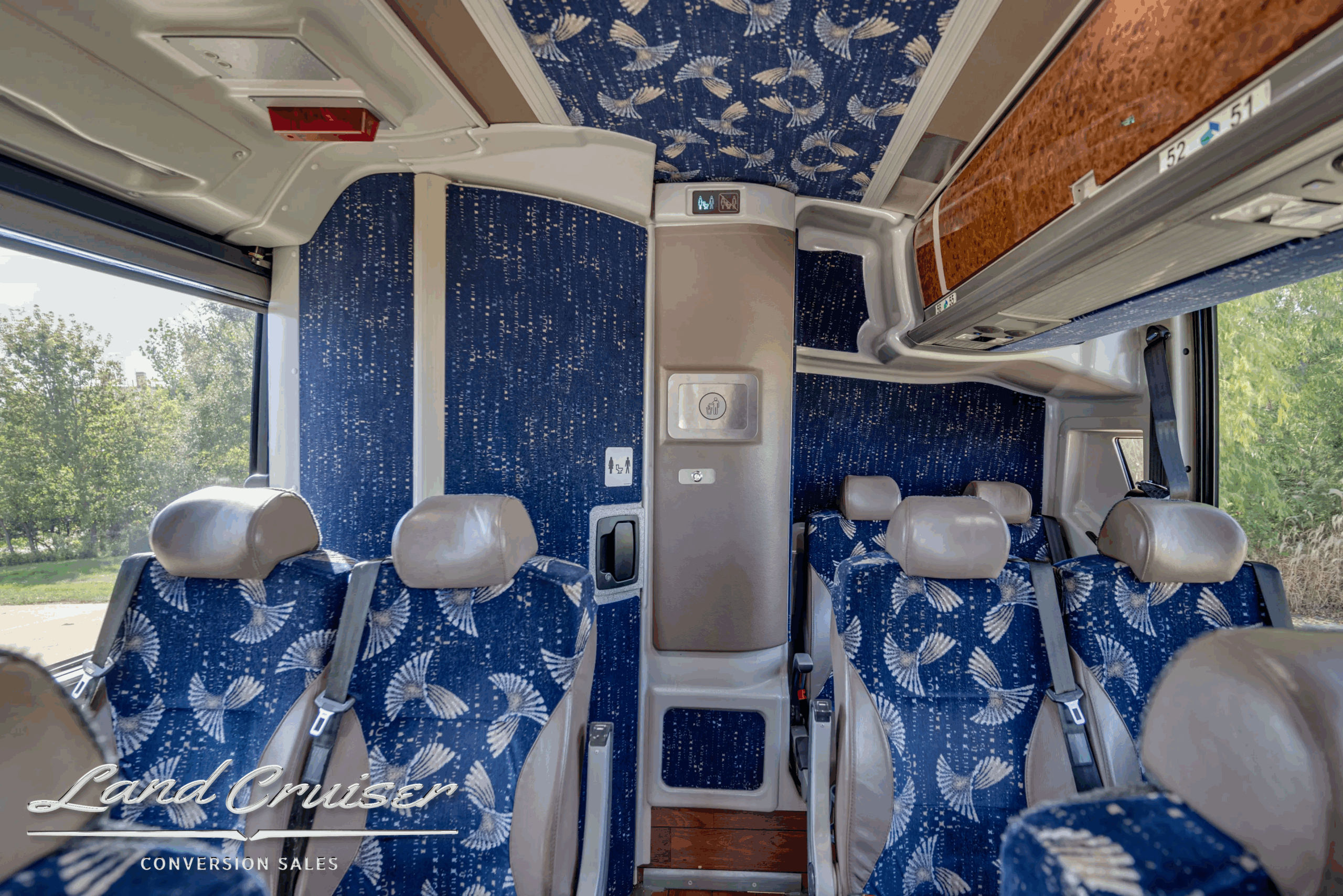 Rear bulkhead and restroom area with seating around it.