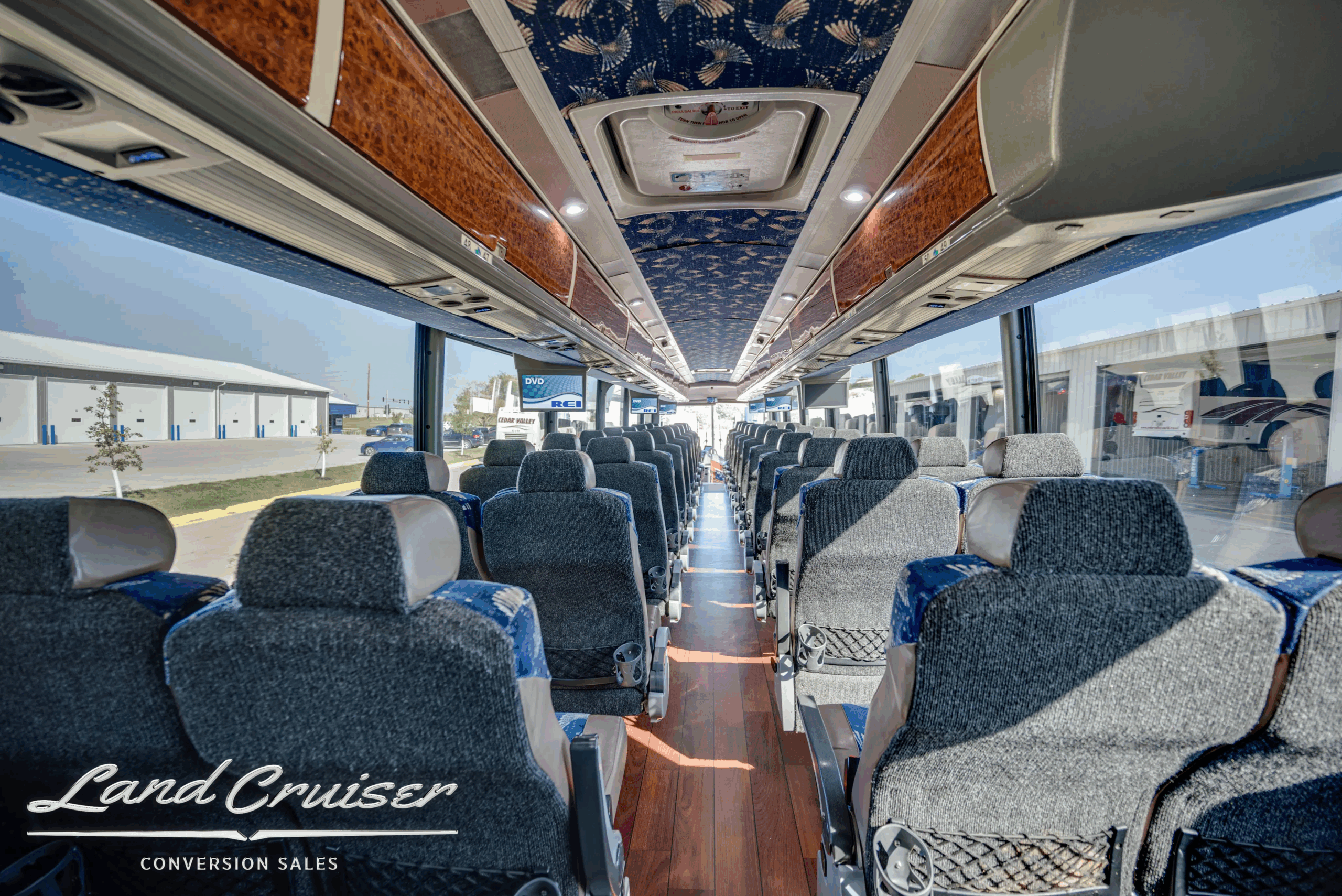 Long aisle perspective toward the front of the coach.