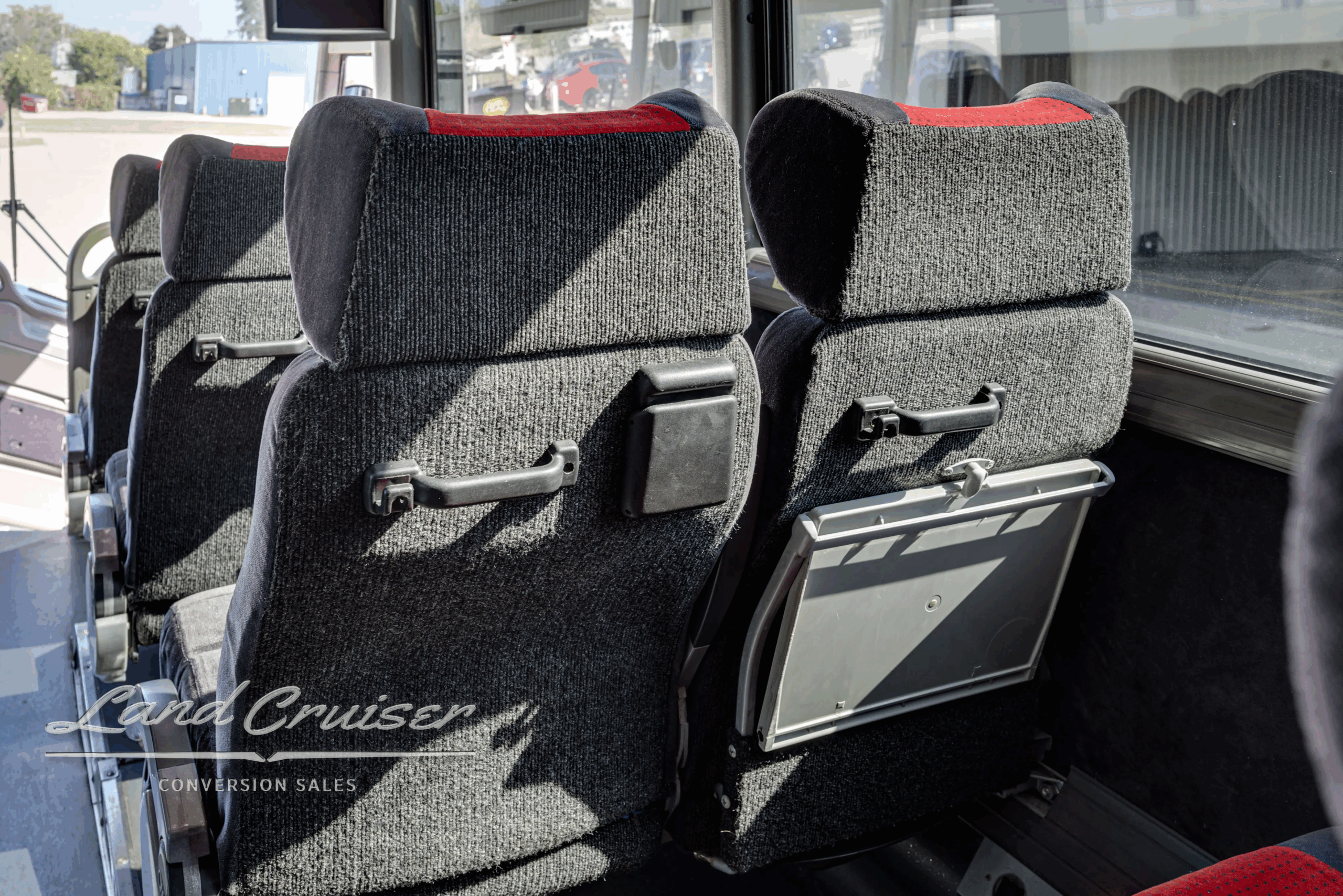 Seat row detail with headrests and fabric pattern.