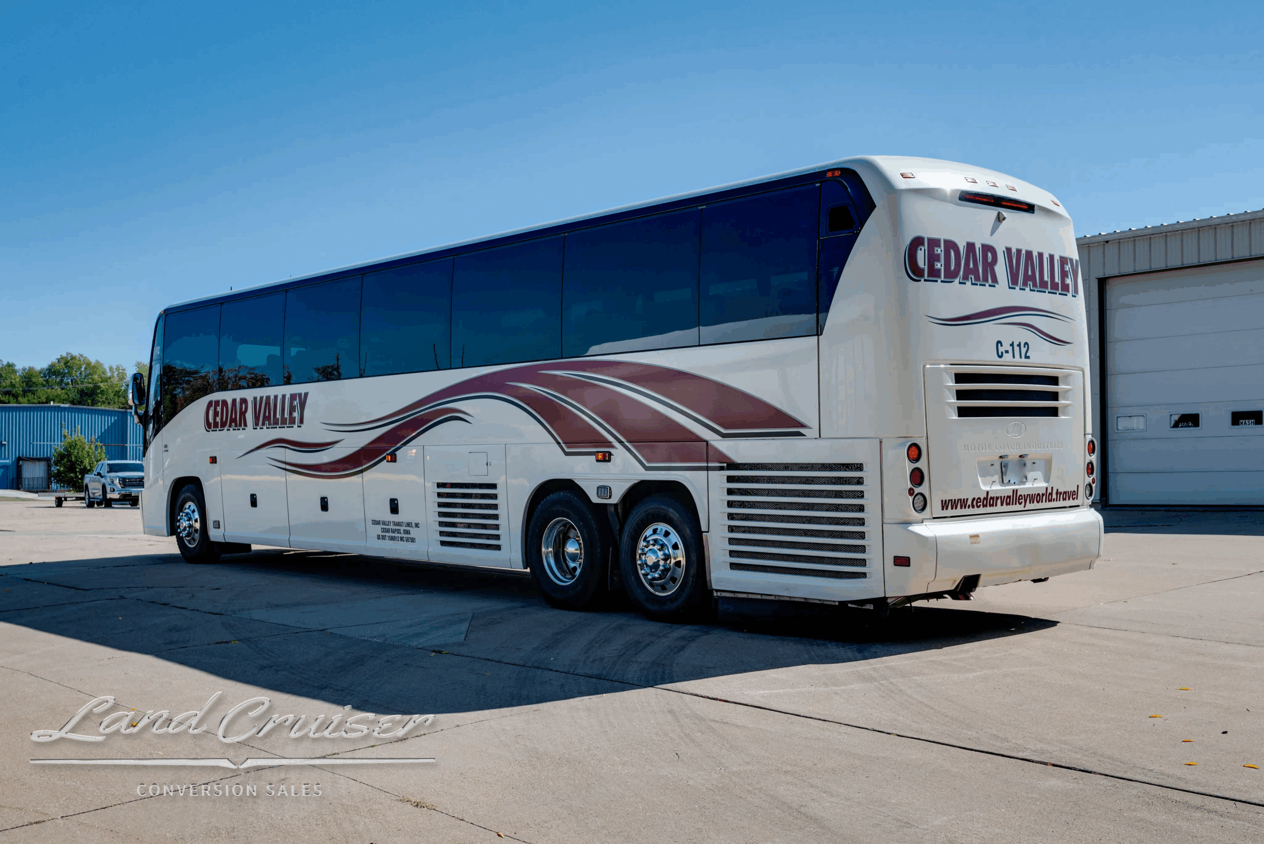 Rear-right three-quarter highlighting tag axle and body lines.