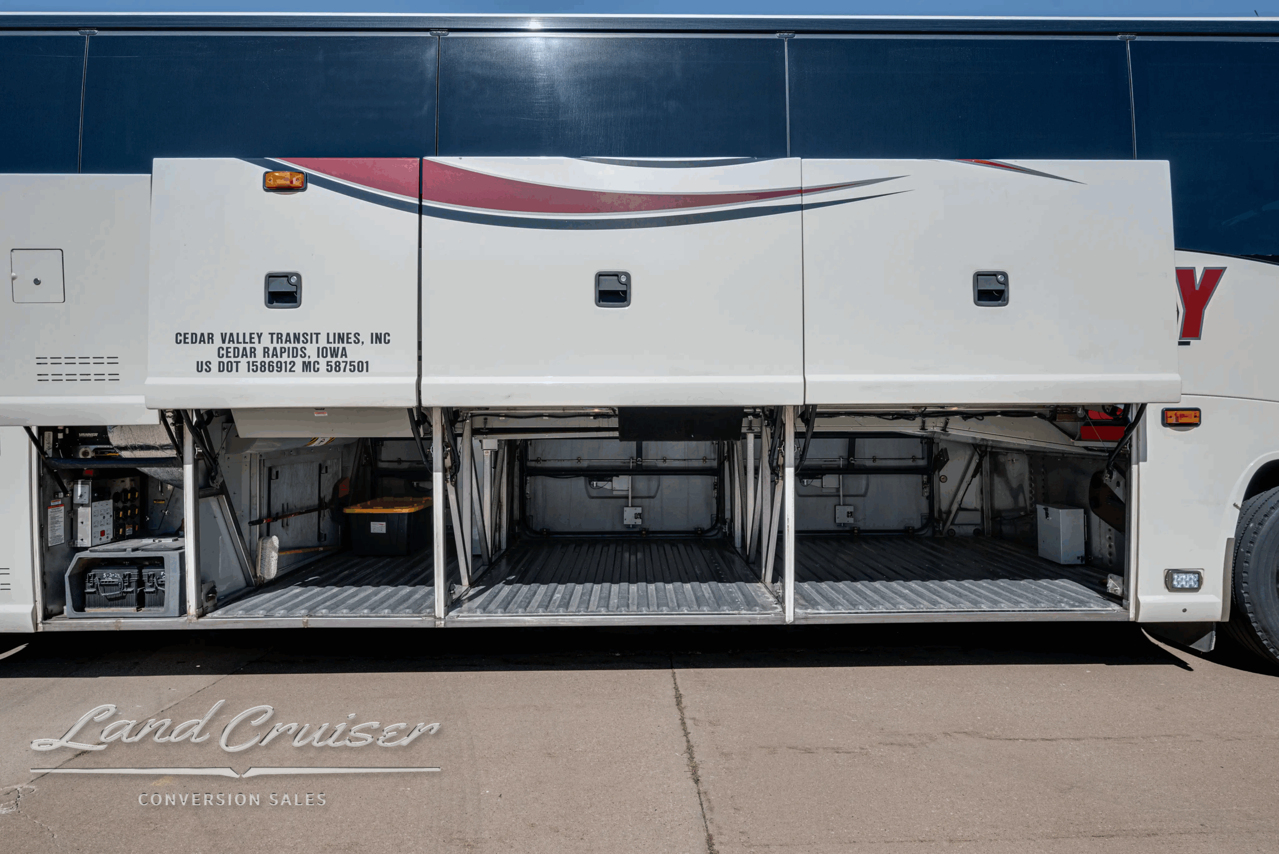 Curb-side view of closed underfloor baggage bays on the J4500.