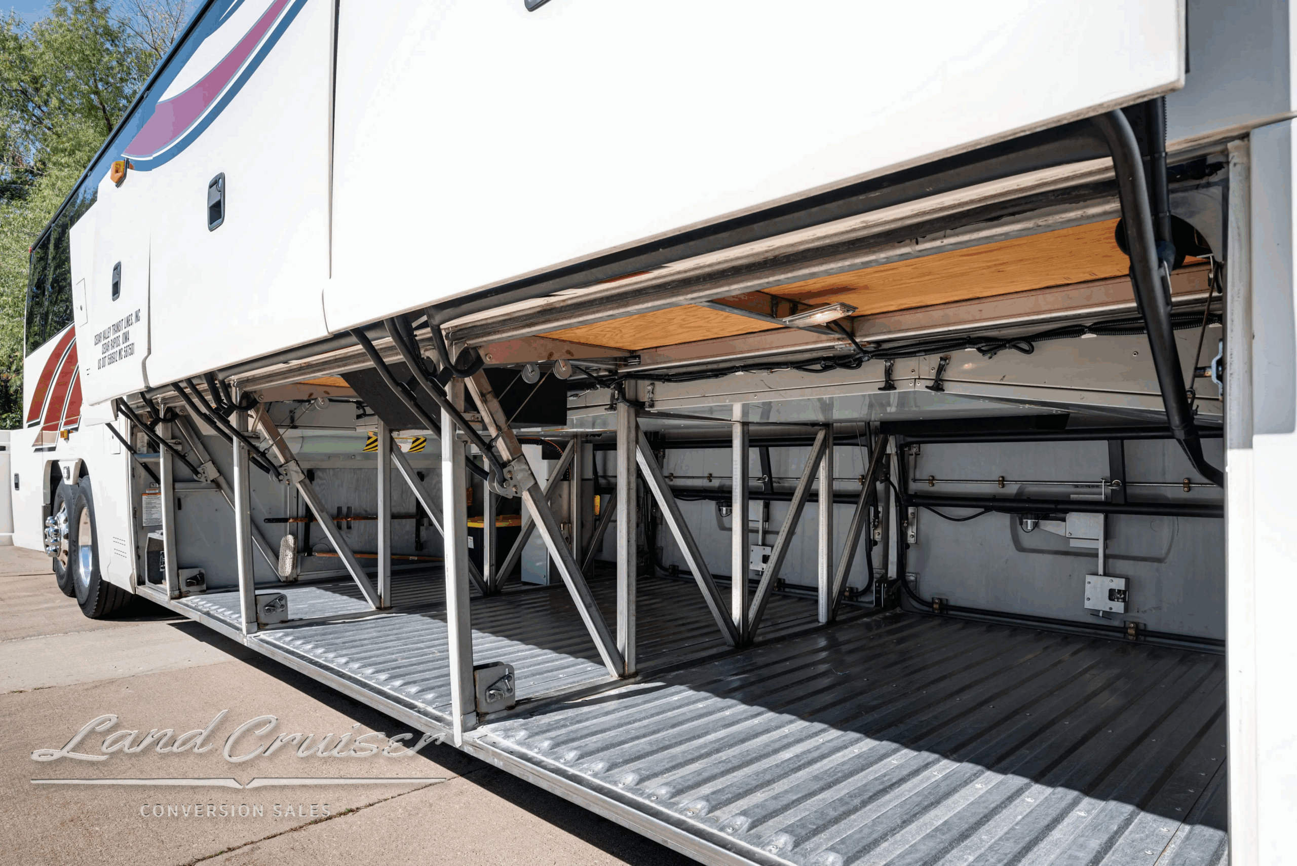 Underfloor luggage bay open showing storage trays.